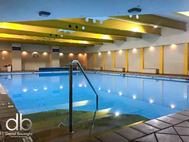 Indoor swimming pool at Jerusalem real estate property by Daniel Bouzaglo, showcasing luxury amenities and modern design.
