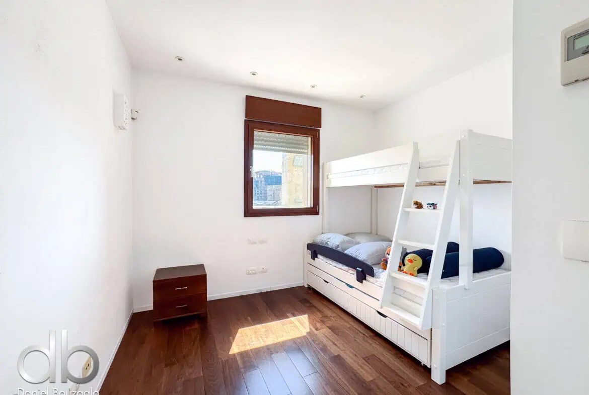 David Crown 25br furnished rental Jerusalem 10 Bright and airy bedroom interior in Jerusalem featuring a white bunk bed, wooden flooring, and a window with city views, perfect for Jerusalem real estate listings.