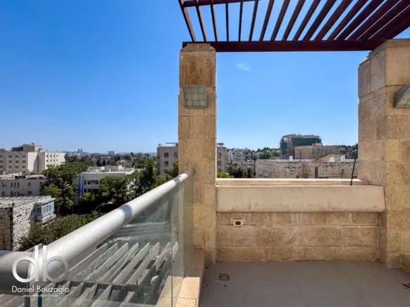 Modern Jerusalem real estate balcony with city view, stone accents, and glass railings, perfect for upscale residential properties.