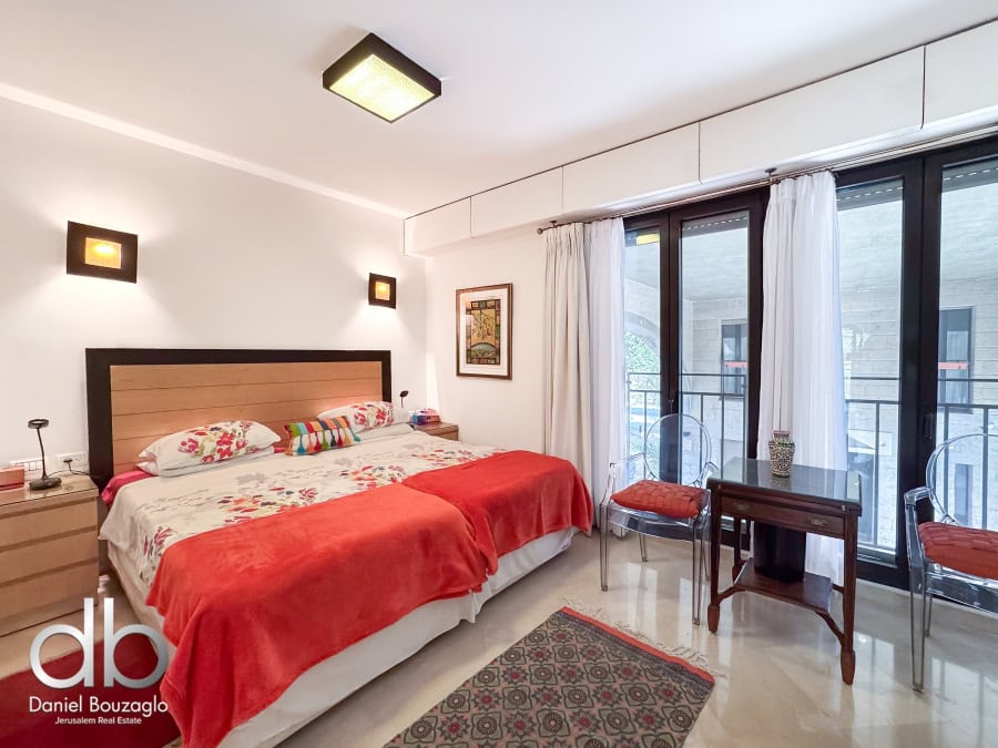 Garden apartment in David VIllage for sale 4 Cozy Jerusalem real estate apartment bedroom with large balcony, modern furnishings, and natural light, ideal for investment or comfortable living in Jerusalem.