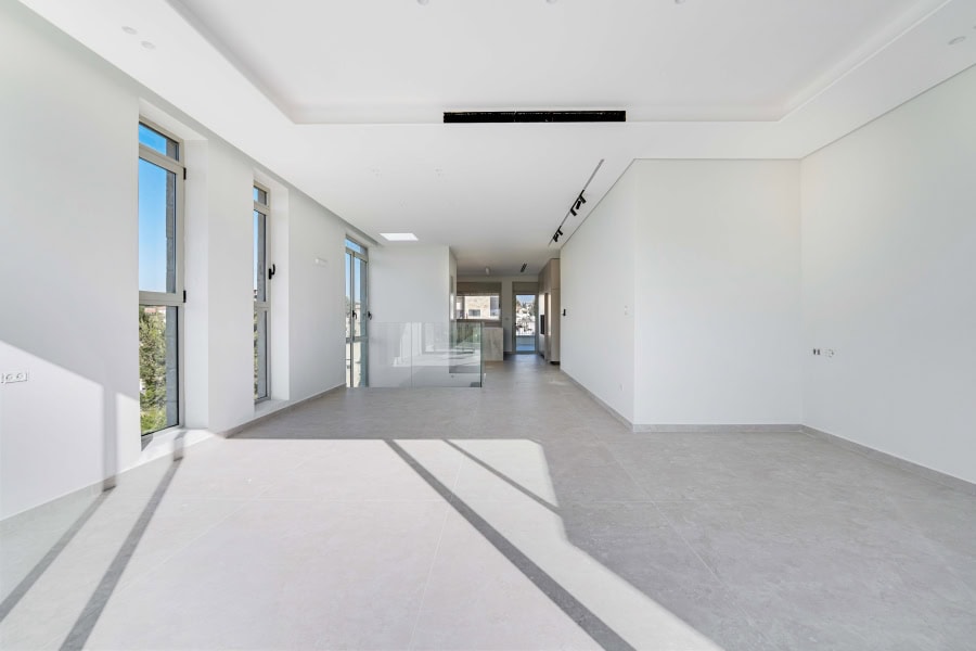 Harakevet rd duplex penthouse for sale 21_1 Bright interiors of Jerusalem real estate property with large windows and modern design features.