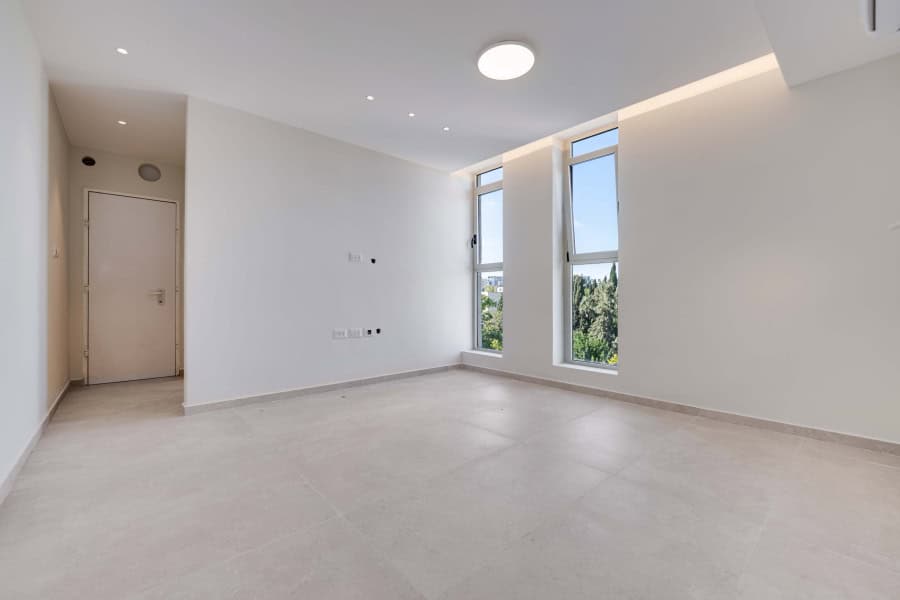 Harakevet rd duplex penthouse for sale 8_1 Bright modern Jerusalem real estate interior with large windows and minimalist design. Perfect space for comfortable living, showcasing elegant apartment features.