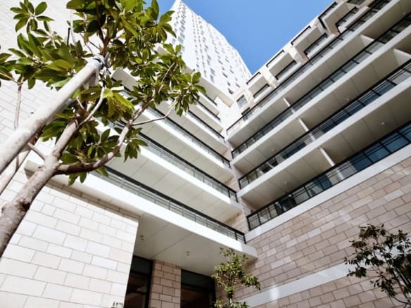 Modern Jerusalem real estate building with glass balconies and contemporary design.