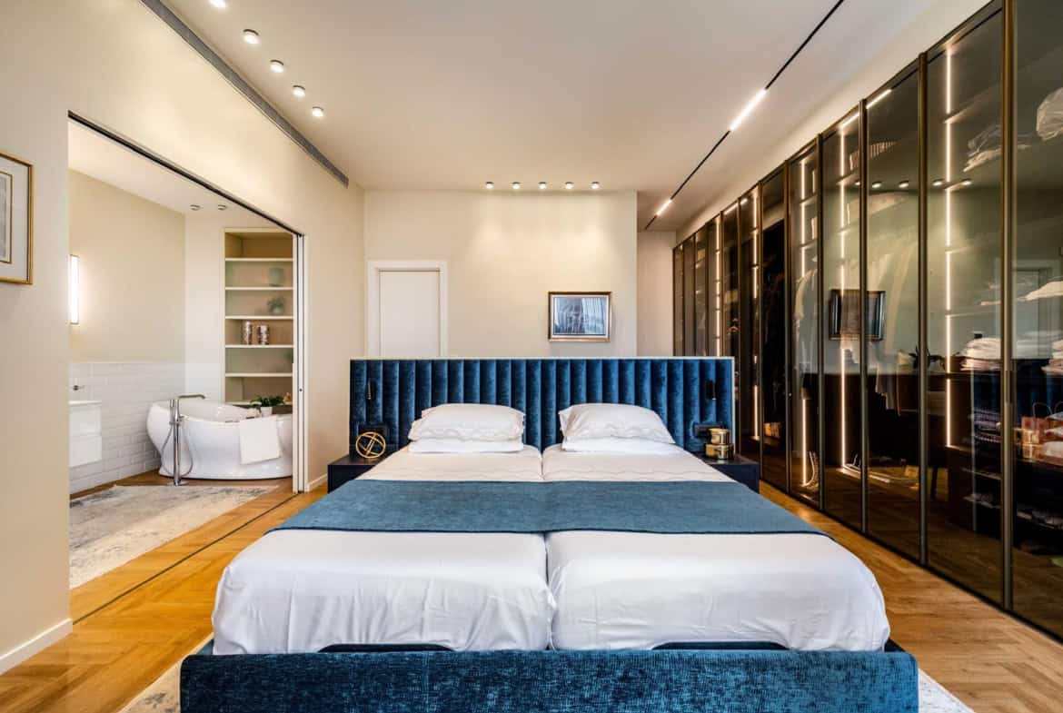 Spacious master bedroom in Jerusalem real estate with modern design, luxurious features, and large walk-in closet for high-end living.