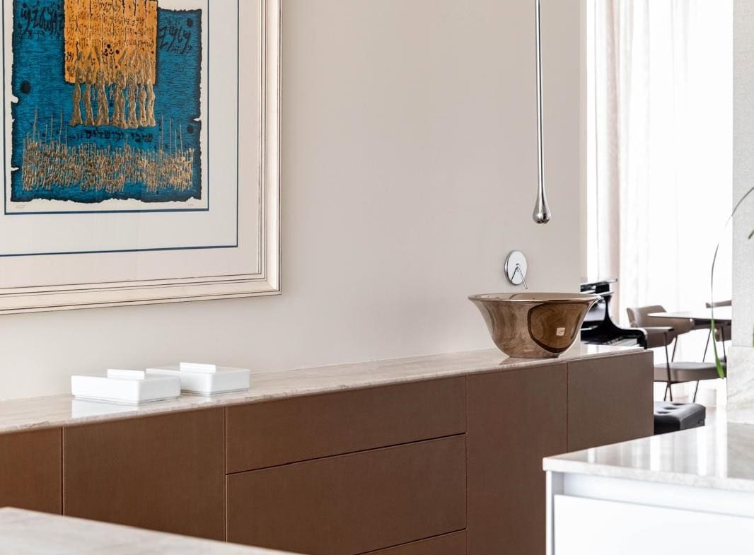 Elegant Jerusalem real estate interior featuring contemporary art, sleek cabinetry, and minimalist design elements.