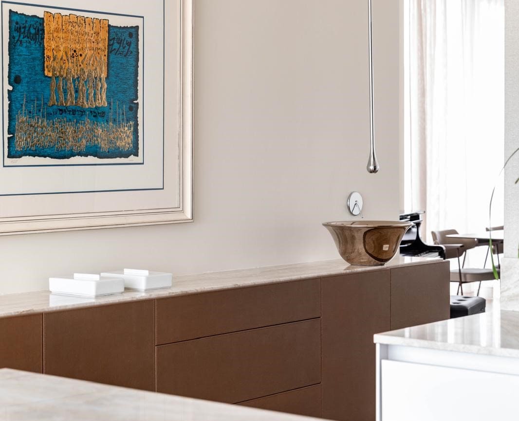 Modern Jerusalem real estate interior with stylish artwork and elegant furnishings. Elegant Jerusalem real estate interior featuring contemporary art, sleek cabinetry, and minimalist design elements.