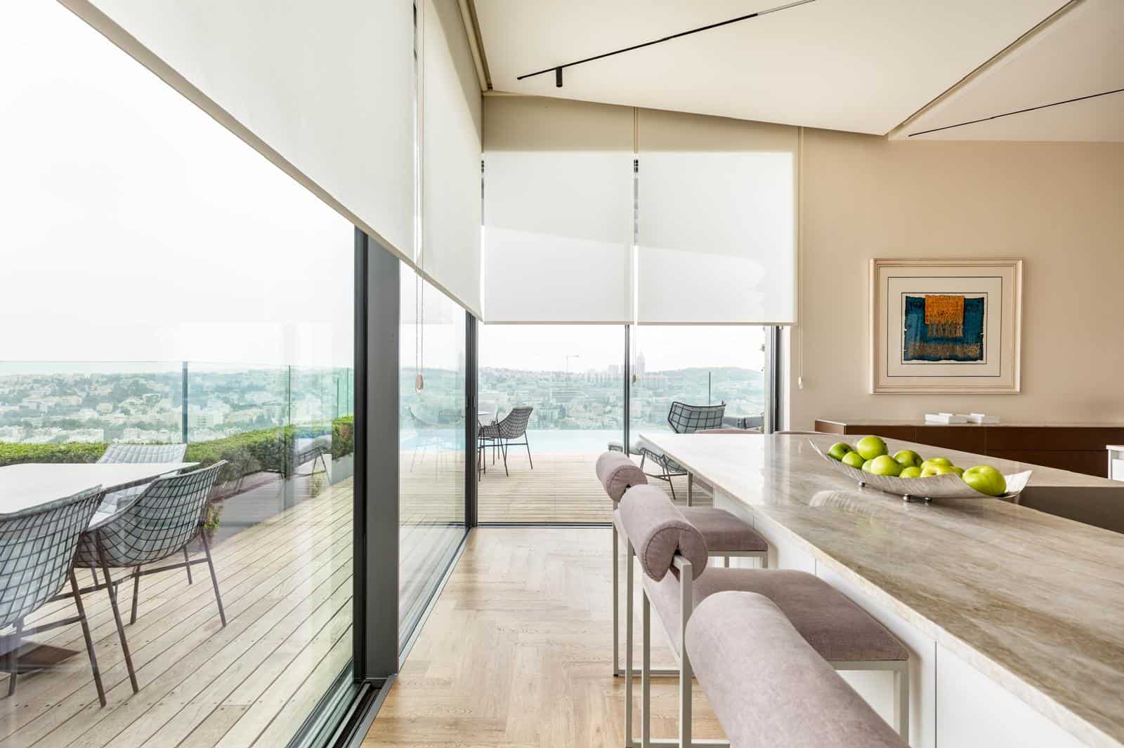 Luxury Jerusalem real estate with modern open-concept interior and panoramic city views. Bright Jerusalem apartment with spacious balcony, stylish furniture, and natural light.