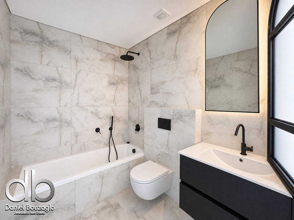 Modern marble-tiled bathroom with a white bathtub, wall-mounted toilet, black fixtures, and a black vanity with an arched mirror.